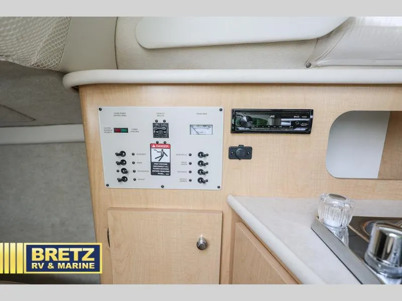 Slide: The Image of Control panel and stereo system in 2000 Bayliner 2455 boat interior. - 28