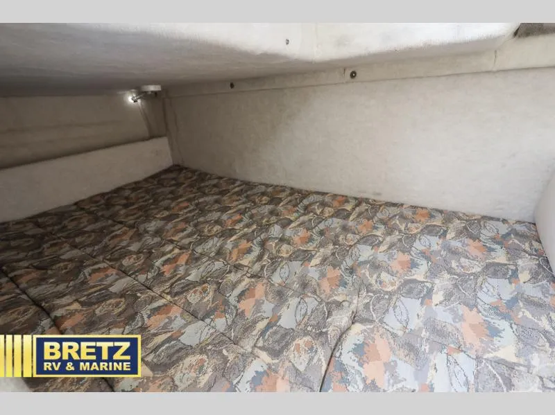 Slide: The Image of Interior cabin of 2000 Bayliner 2455 with patterned bedding. - 30