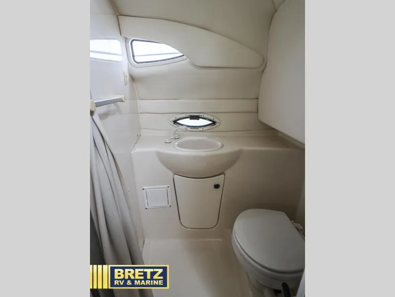 Slide: The Image of Compact bathroom in 2000 Bayliner 2455 boat with sink and toilet. - 31