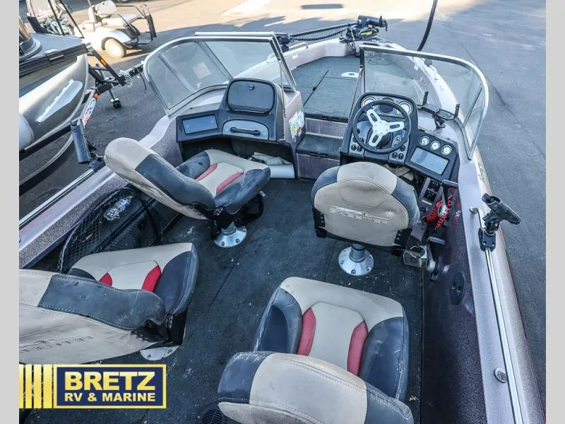 Slide: The Image of 2015 Skeeter WX1850 boat interior with four seats and steering console. - 12
