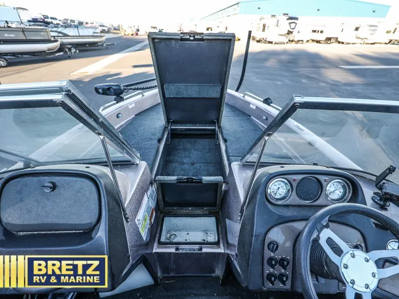 Slide: The Image of 2015 Skeeter WX1850 boat interior with open storage, steering wheel, and dashboard gauges at Bretz RV & Marine. - 28