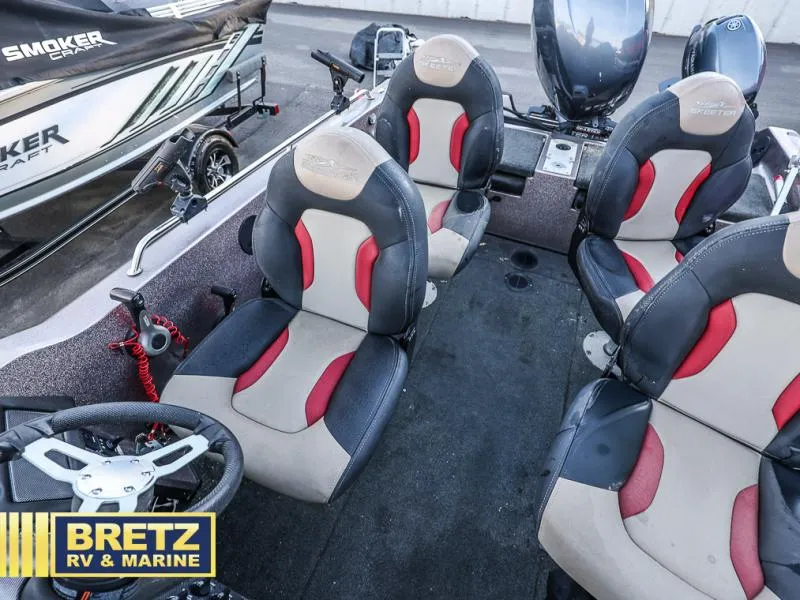Slide: The Image of 2015 Skeeter WX1850 boat interior with four cushioned seats and steering wheel. - 7