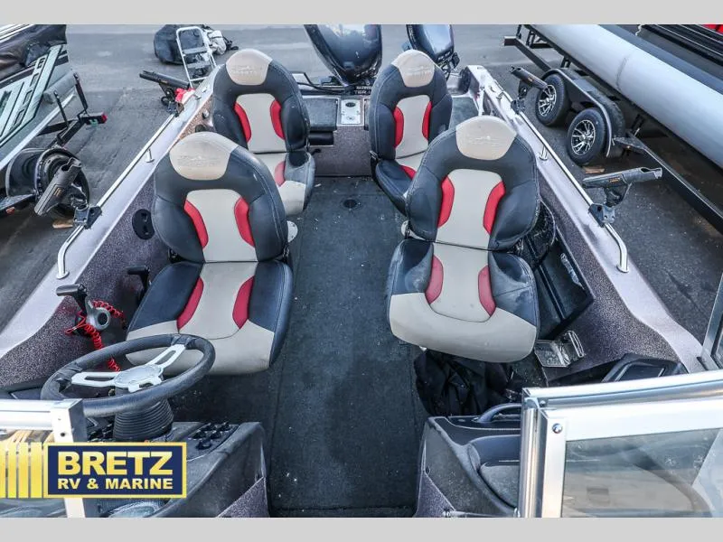 Slide: The Image of 2015 Skeeter WX1850 boat interior with four seats and steering wheel. - 9