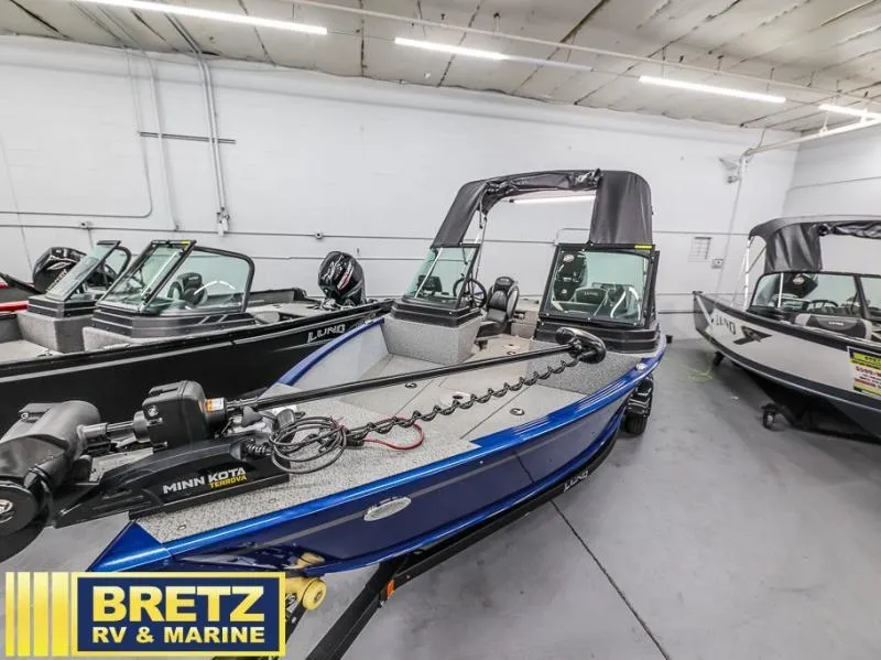 Slide: The Image of 2024 Adventure 1775 Sport boat in showroom, featuring Minn Kota trolling motor. - 3