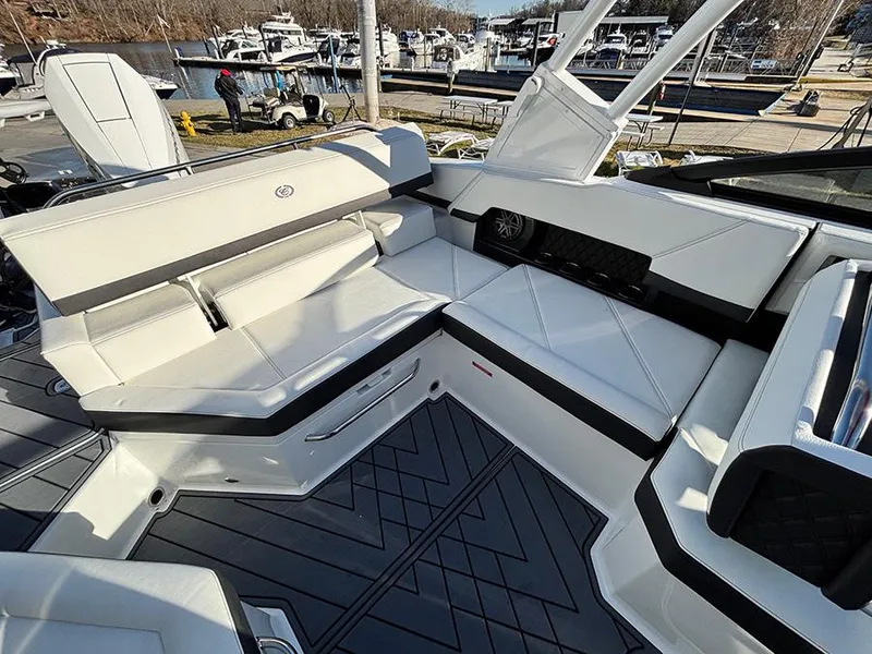 Slide: The Image of 2025 Cobalt R4 Outboard boat interior with luxurious seating and modern design at a marina. - 10