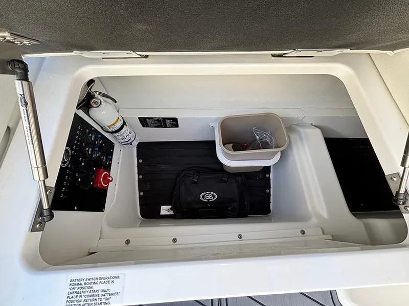 Slide: The Image of Storage compartment of 2025 Cobalt R4 Outboard boat with fire extinguisher and gear. - 13