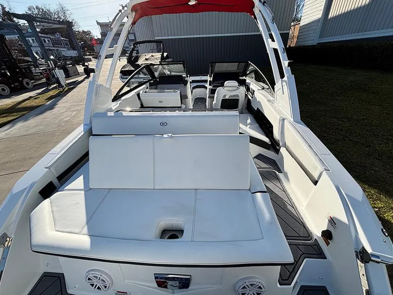Slide: The Image of 2025 Cobalt R4 Outboard boat with white seating and red canopy, docked outdoors. - 8