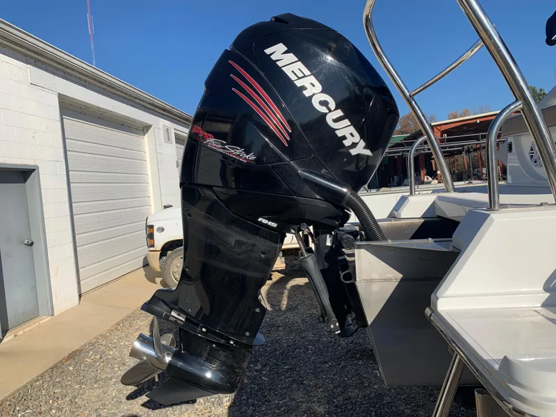 Slide: The Image of Mercury outboard motor on a Marker One ML4 boat, 2017 model, in a sunny outdoor setting. - 25