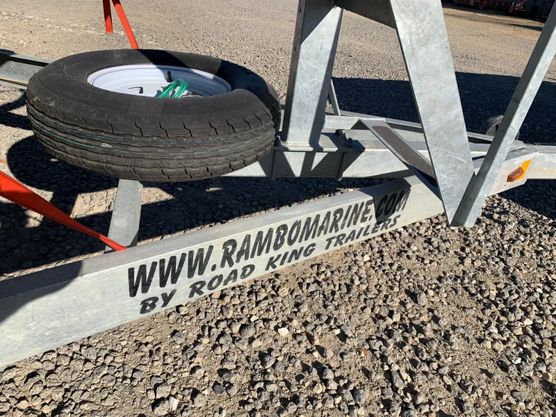 Slide: The Image of Boat trailer by Road King Trailers, featuring spare tire, gravel ground, Marker One ML4, 2017. - 30
