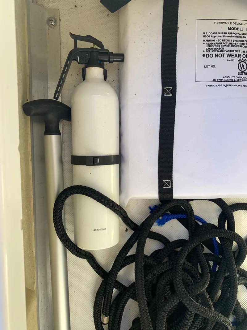 Slide: The Image of Boat storage compartment with fire extinguisher, rope, and paddle; Marker One ML4, 2017 model. - 31