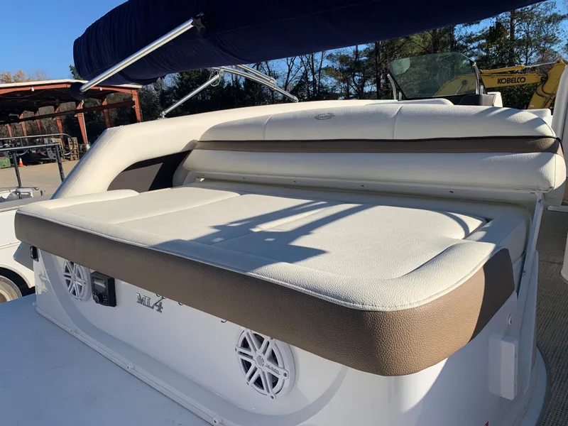 Slide: The Image of 2017 Marker One ML4 boat with cushioned seating and speakers, docked outdoors. - 5