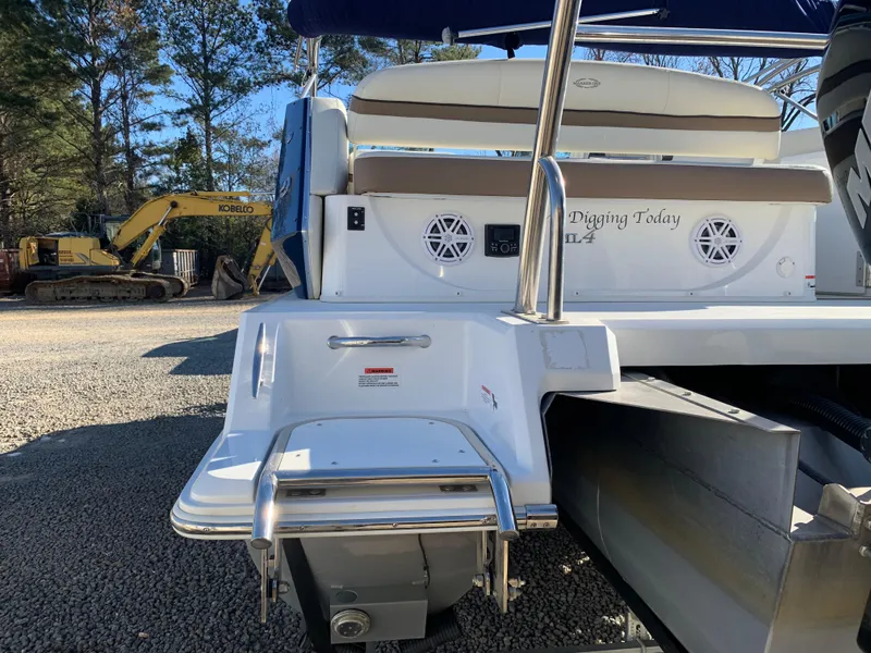 Slide: The Image of Marker One ML4 boat rear view with speakers and construction equipment in the background. - 7