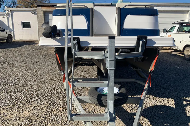 Slide: The Image of Marker One ML4 boat on trailer, rear view, parked on gravel lot, 2017 model. - 8