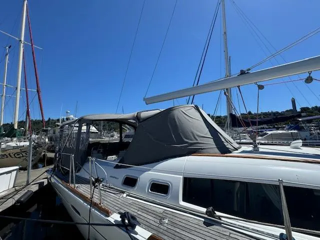 Slide: The Image of 2007 Beneteau 49 sailboat docked at marina under clear blue sky. - 16