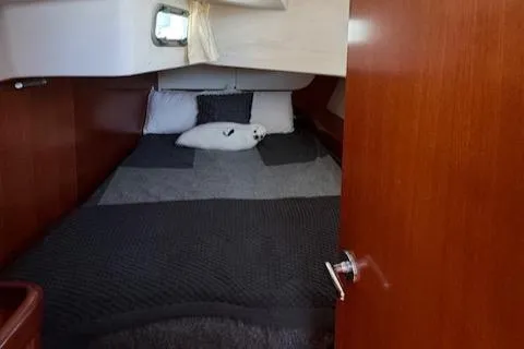 Slide: The Image of Cozy cabin interior of 2007 Beneteau 49 sailboat with plush bedding. - 23