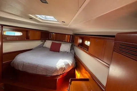 Slide: The Image of Luxurious cabin interior of 2007 Beneteau 49 yacht with cozy bed and wooden finish. - 24