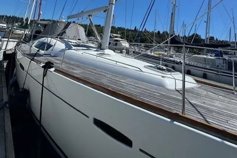 Slide: The Image of 2007 Beneteau 49 yacht docked in marina, sleek design, sunny day. - 27