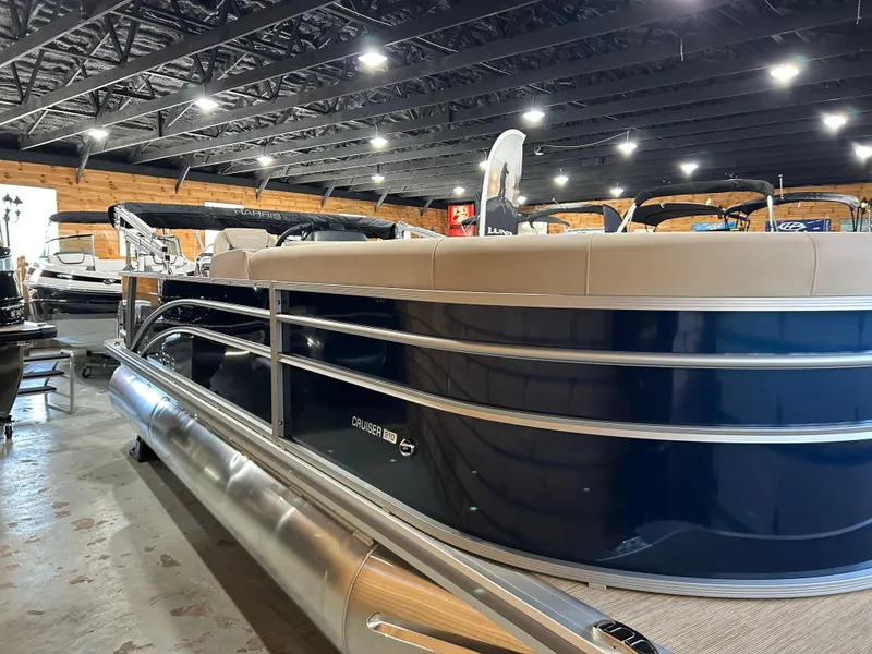 Slide: The Image of 2025 Harris Cruiser 210 FC pontoon boat in showroom, side view. - 0