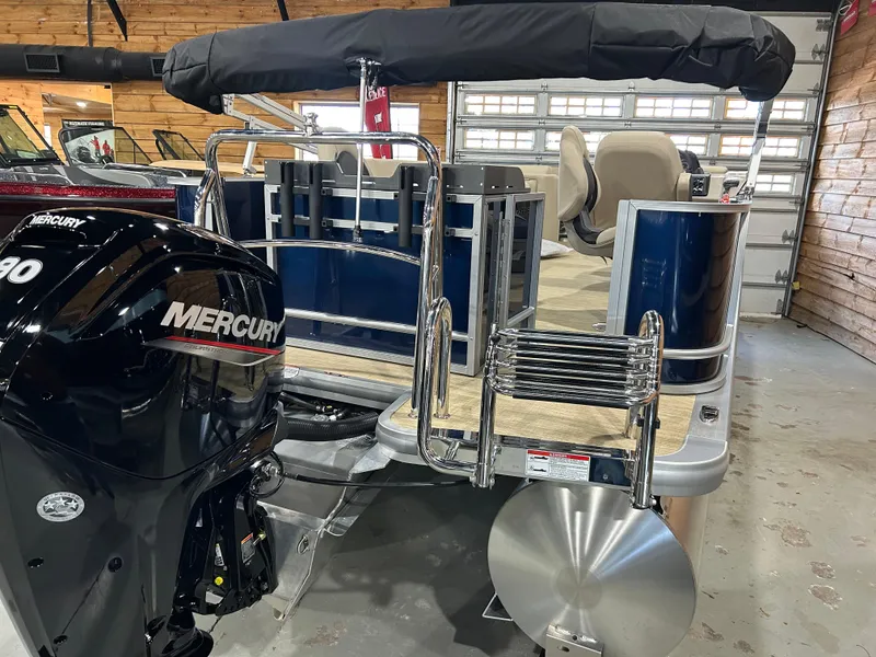 Slide: The Image of 2025 Harris Cruiser 210 FC pontoon boat with Mercury engine in showroom. - 1