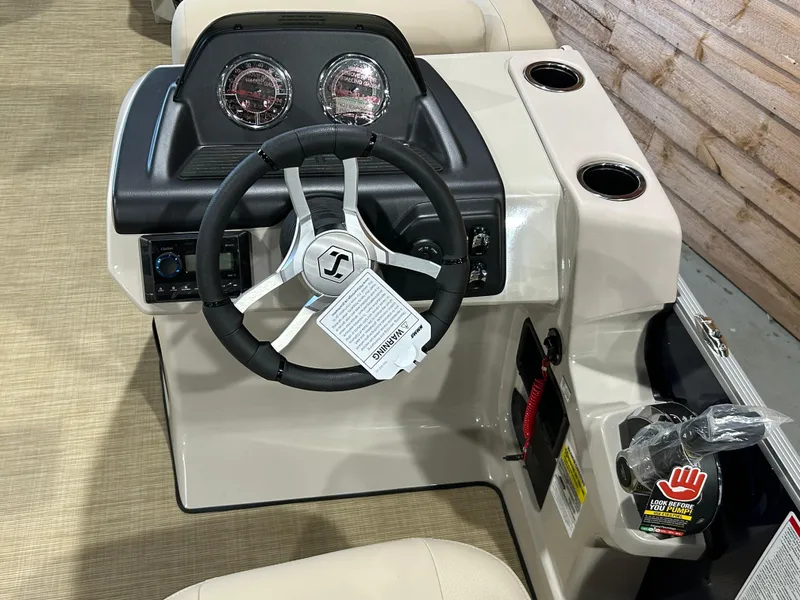 Slide: The Image of 2025 Harris Cruiser 210 FC boat dashboard with steering wheel and gauges. - 11