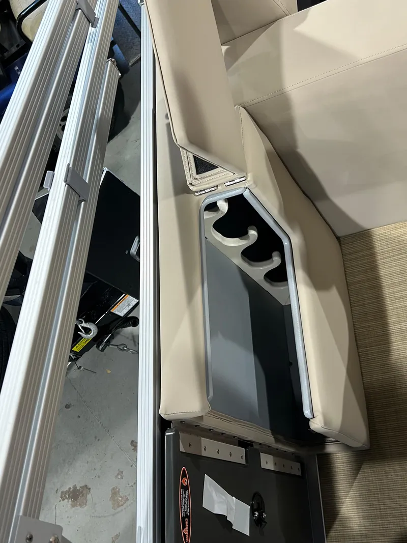 Slide: The Image of 2025 Harris Cruiser 210 FC boat interior with cup holders and beige seating. - 12