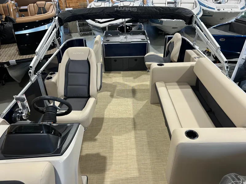 Slide: The Image of 2025 Harris Cruiser 210 FC interior with beige seating and steering console. - 9