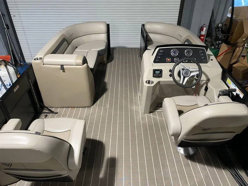 Slide: The Image of 2022 Viaggio Lago U L22U pontoon boat interior with beige seating and steering console. - 12