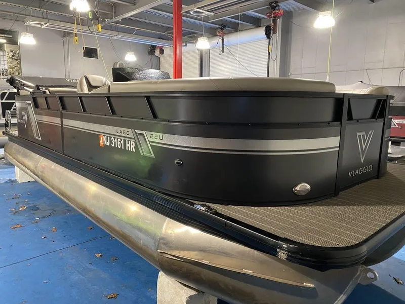 Slide: The Image of 2022 Viaggio Lago U L22U pontoon boat in showroom, black exterior, modern design. - 4