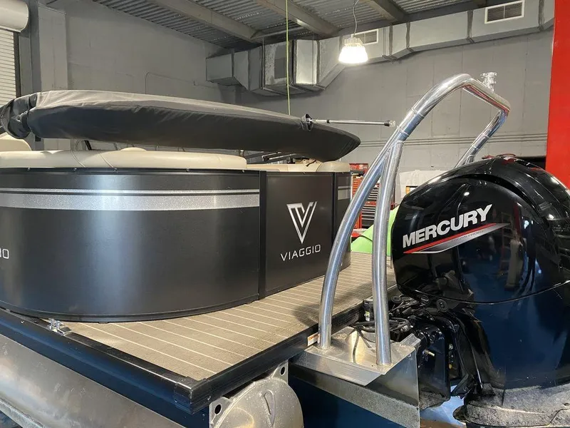 Slide: The Image of 2022 Viaggio Lago U L22U pontoon boat with Mercury engine in a garage. - 6