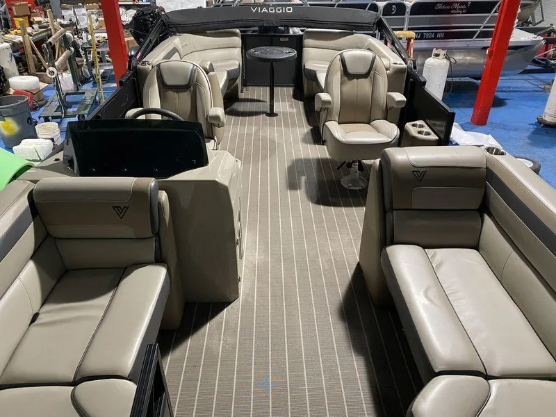 Slide: The Image of Viaggio Lago U L22U 2022 boat interior with beige seating and central table. - 7