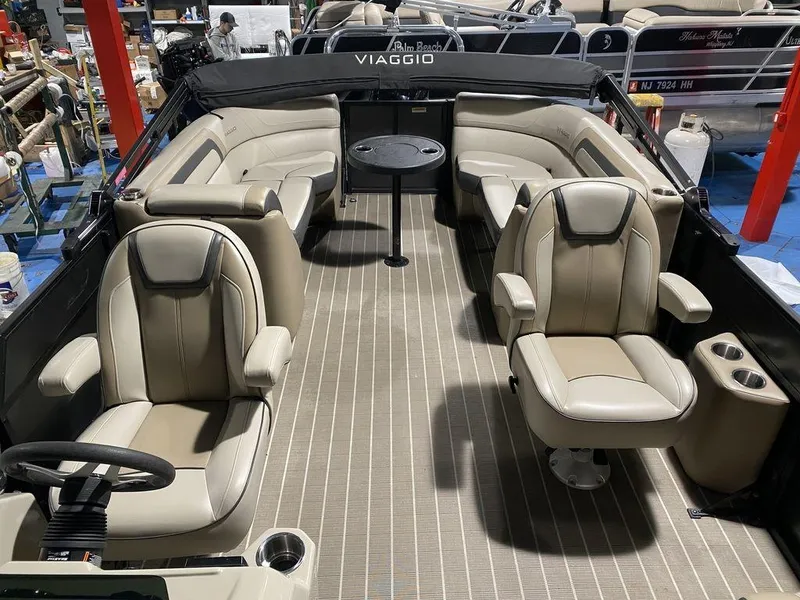 Slide: The Image of 2022 Viaggio Lago U L22U boat interior with beige seating and central table. - 8