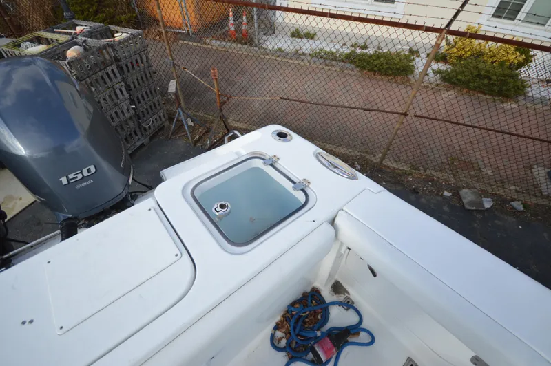 Slide: The Image of 2015 Sea Hunt Gamefish 27 boat deck with Yamaha 150 engine and storage compartment. - 12