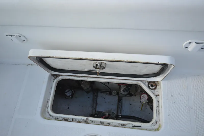 Slide: The Image of Open hatch on 2015 Sea Hunt Gamefish 27 boat, showing interior compartment. - 13