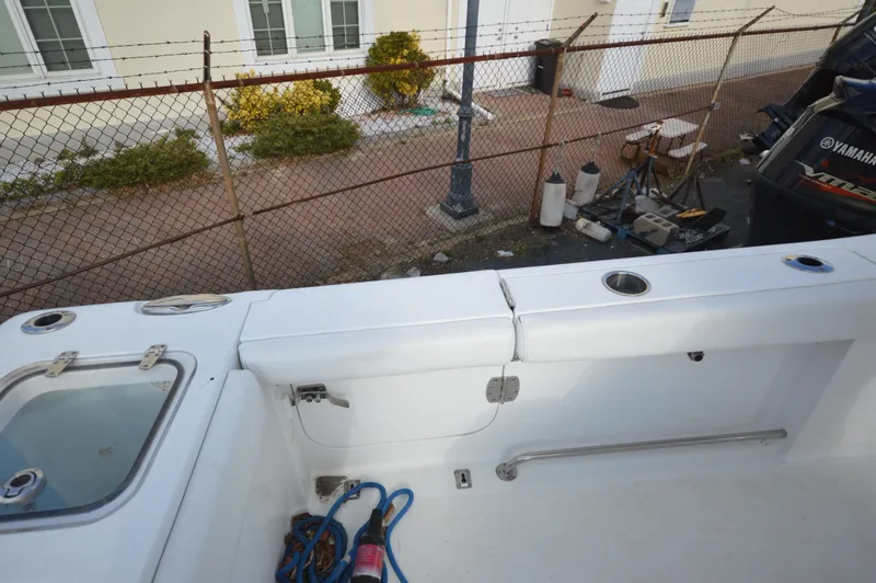 Slide: The Image of 2015 Sea Hunt Gamefish 27 boat deck with fishing rod holders and equipment. - 15