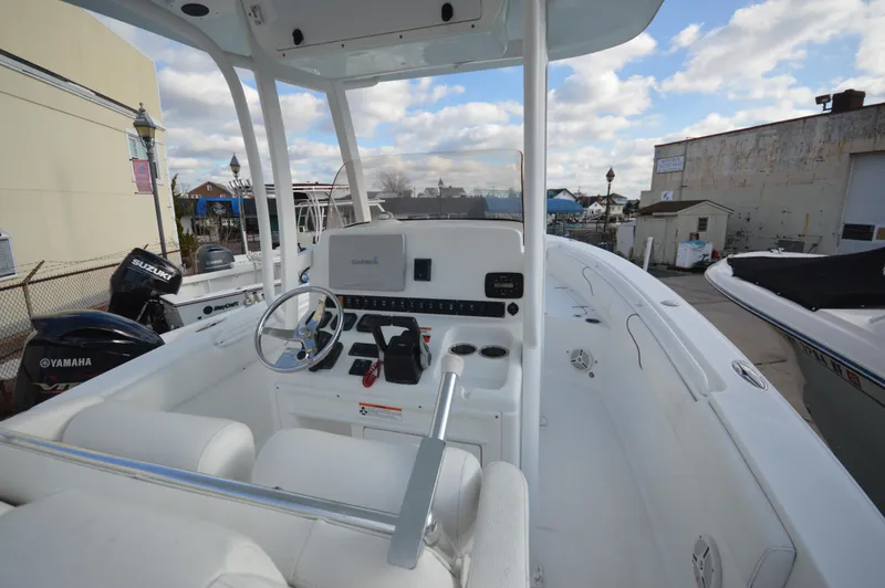 Slide: The Image of 2015 Sea Hunt Gamefish 27 boat interior with steering console and seating. - 17