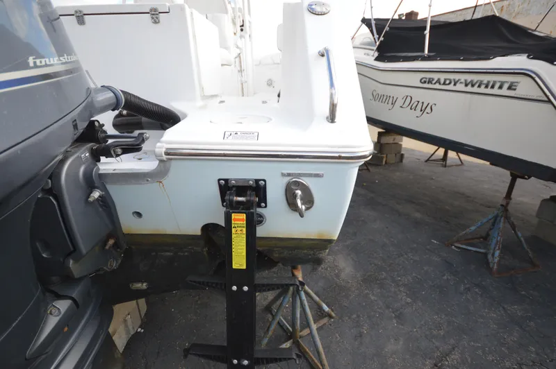 Slide: The Image of 2015 Sea Hunt Gamefish 27 boat on trailer, parked beside another boat. - 3
