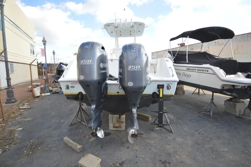 Slide: The Image of 2015 Sea Hunt Gamefish 27 with twin Yamaha 150 engines, parked on a lot. - 8