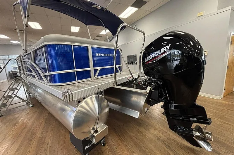 Slide: The Image of 2025 Bennington S 21 Cruise pontoon boat with Mercury outboard motor in showroom. - 14