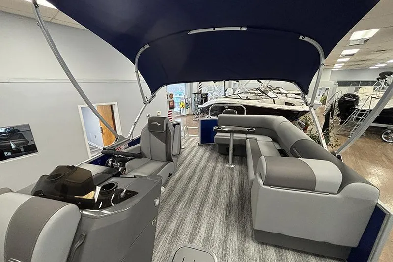 Slide: The Image of 2025 Bennington S 21 Cruise pontoon boat interior with seating and canopy. - 17