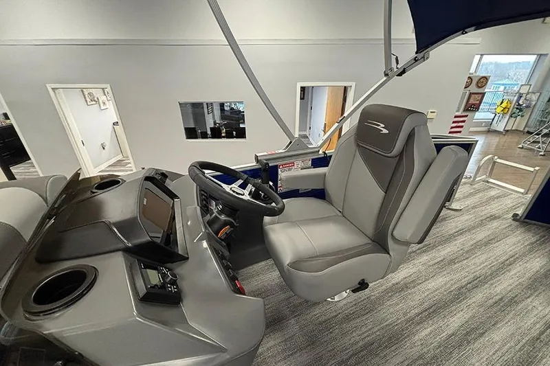 Slide: The Image of 2025 Bennington S 21 Cruise boat interior with modern helm and comfortable seating. - 18