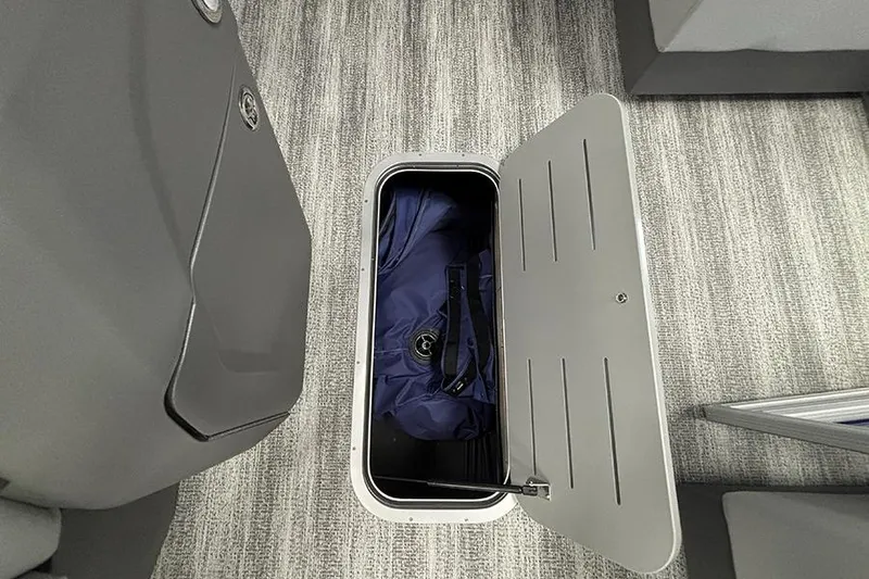Slide: The Image of Storage compartment on 2025 Bennington S 21 Cruise boat with blue bag inside. - 20