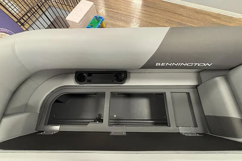 Slide: The Image of 2025 Bennington S 21 Cruise boat interior with storage compartments and cup holders. - 21