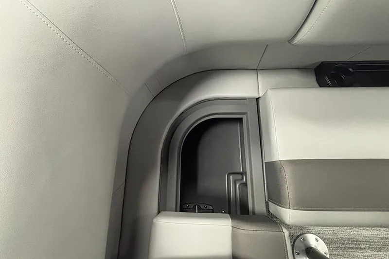 Slide: The Image of 2025 Bennington S 21 Cruise interior seating with storage compartment. - 22