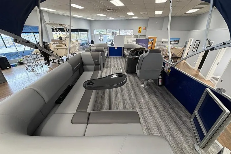Slide: The Image of 2025 Bennington S 21 Cruise pontoon boat interior with gray seating and modern design. - 23