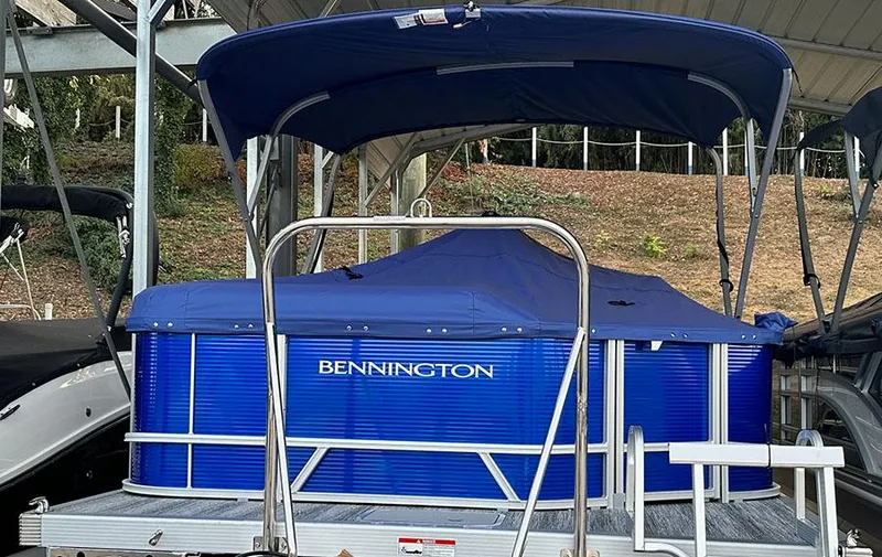 Slide: The Image of 2025 Bennington S 21 Cruise pontoon boat with blue cover and canopy. - 7