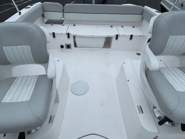 Slide: The Image of 2022 Sea Fox 226 Traveler boat interior with cushioned seating and storage compartments. - 13