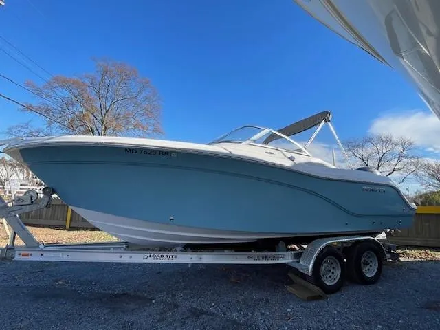 Slide: The Image of 2022 Sea Fox 226 Traveler boat on trailer, parked outdoors under clear blue sky. - 4