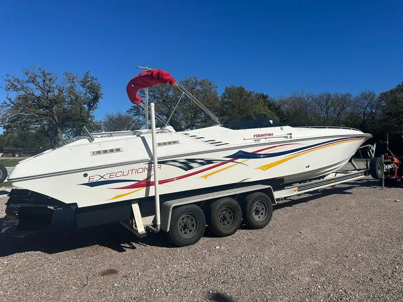 Slide: The Image of 2003 Fountain 35 Executioner speedboat on trailer, parked outdoors. - 2