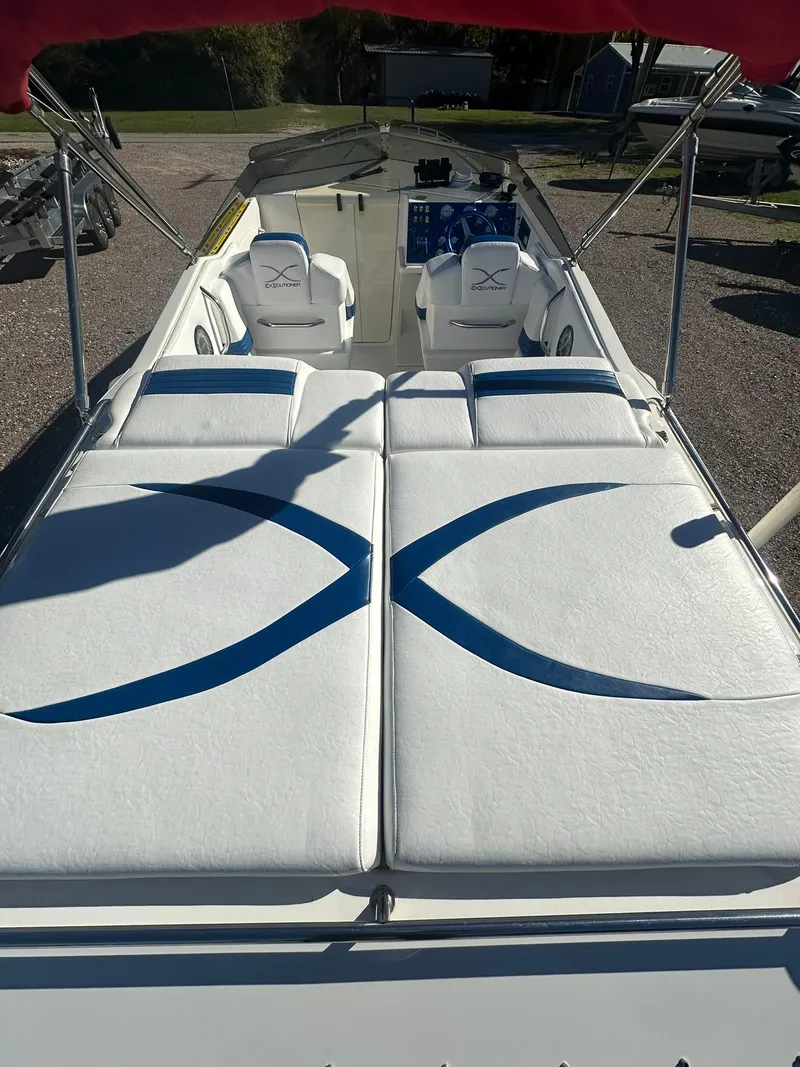 Slide: The Image of 2003 Fountain 35 Executioner boat with white and blue seating, outdoor setting. - 4