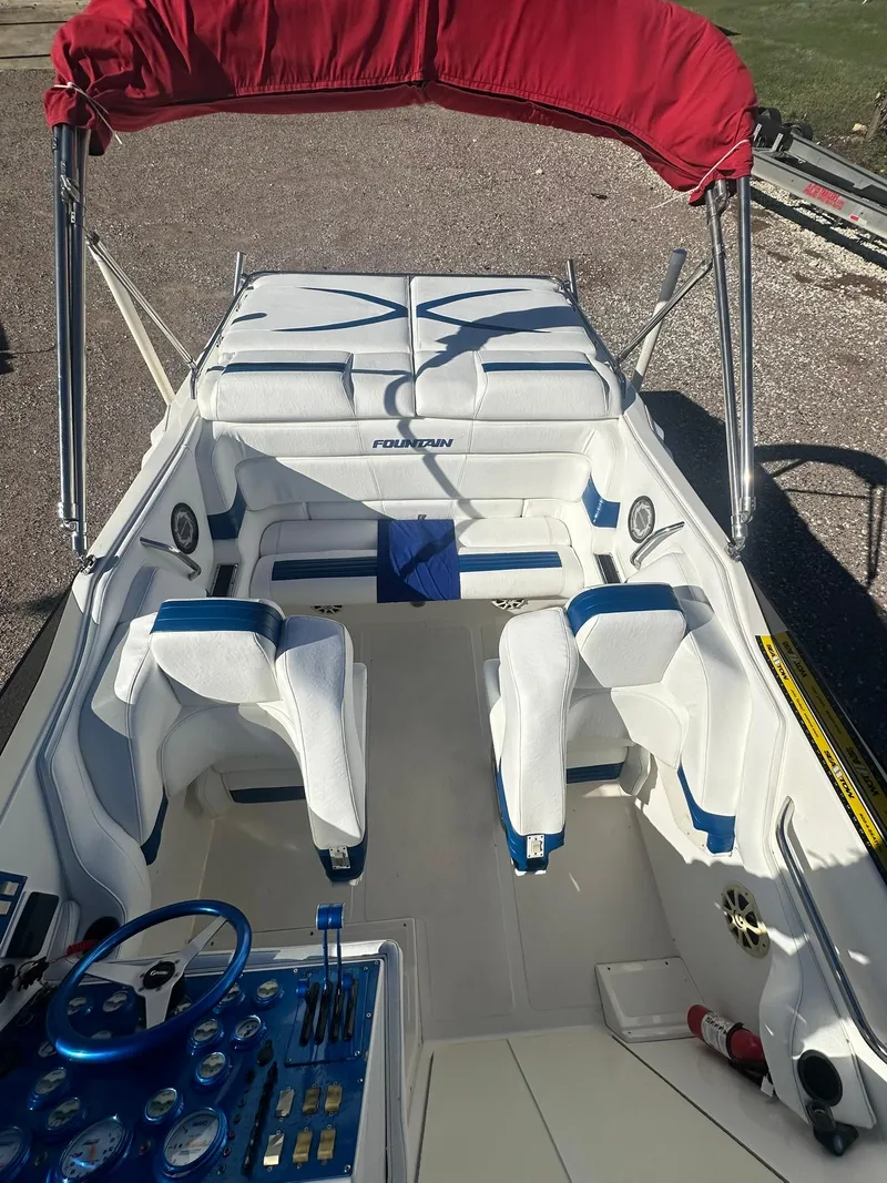 Slide: The Image of 2003 Fountain 35 Executioner boat with red canopy and white seating. - 9